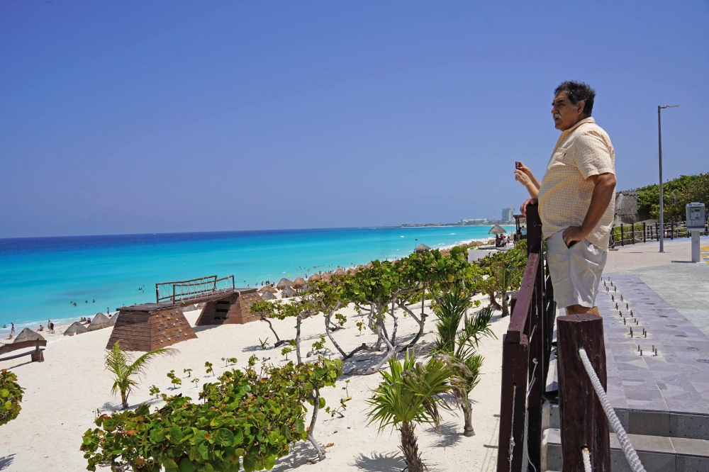 A man looks out to sea at a beach before the potential arrival of Hurricane Beryl in Cancun, Quintana Roo State, Mexico, on July 3, 2024. (Photo by Elizabeth Ruiz / AFP)