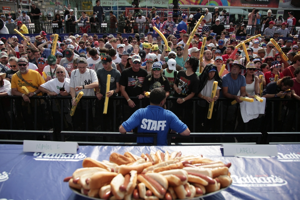 People attend the 2024 Nathan's Famous Fourth of July hot dog eating competition at Coney Island in the Brooklyn borough of New York on July 4, 2024. (Photo by Leonardo Munoz / AFP)