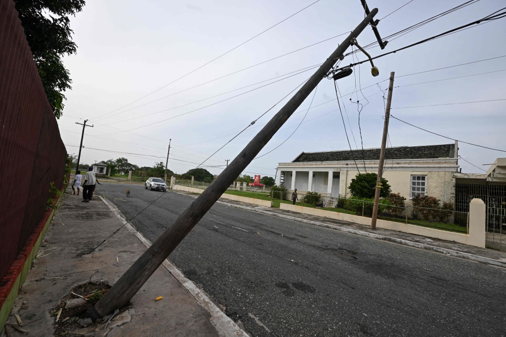 A light pole leans out of its foundation at National Heroes Park in Kingston, Jamaica, in the aftermath of Hurricane Beryl on July 4,2024. (Photo by Ricardo Makyn / AFP)
