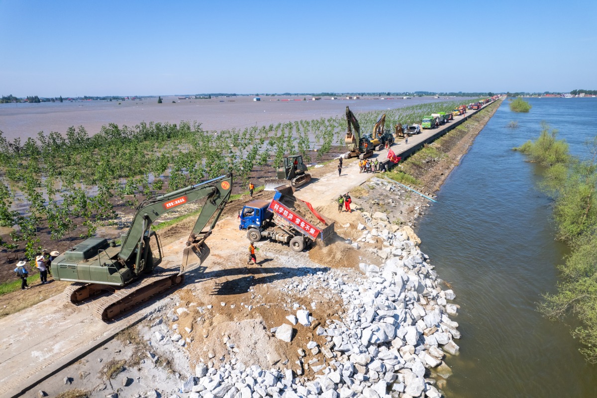 A drone photo taken on July 6, 2024 shows Rescuers working to block a dike breach in Tuanzhou Township, Huarong County under Yueyang City, central China's Hunan Province. (Xinhua/Chen Sihan)
