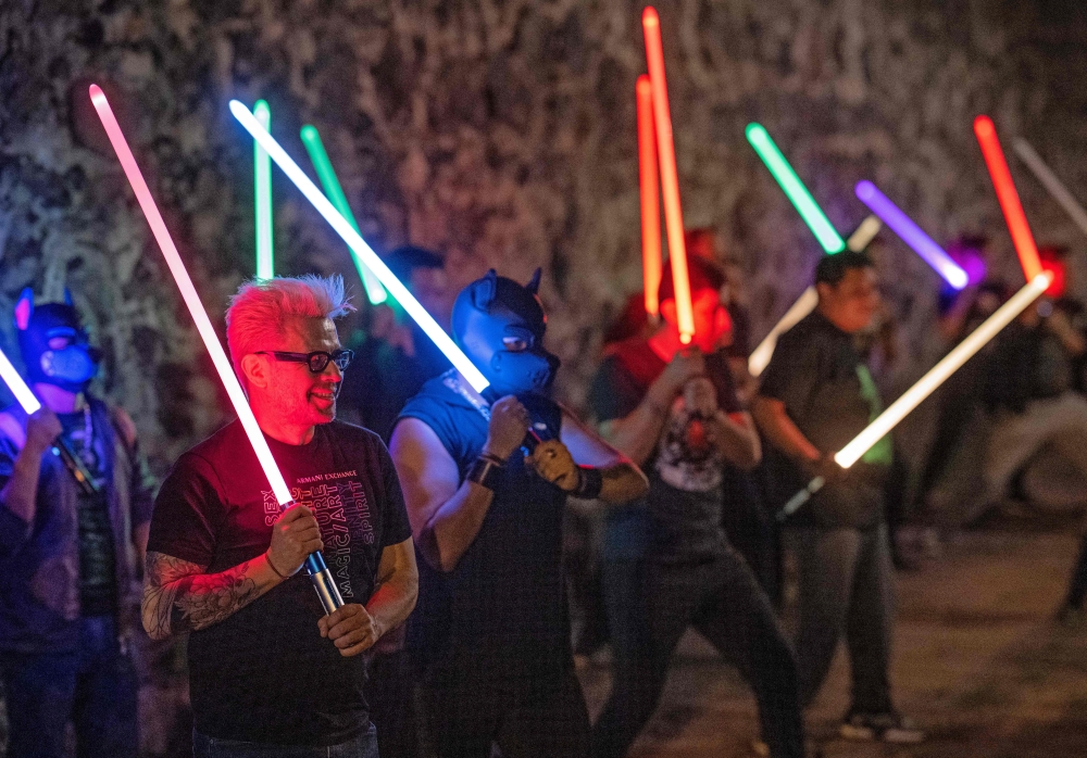 Members of the Jedi Knight Academy (JKAMX) hold light sabers during a group practice session at a park in Mexico City on July 6, 2024. (Photo by CARL DE SOUZA / AFP)

