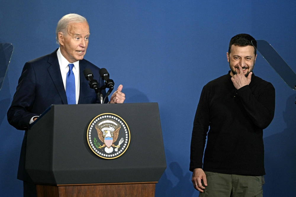 US President Joe Biden corrects himself after accidentally introducing Ukraine's President Volodymyr Zelensky (R) as Russia's President Vladimir Putin on July 11, 2024. (Photo by Brendan Smialowski / AFP)