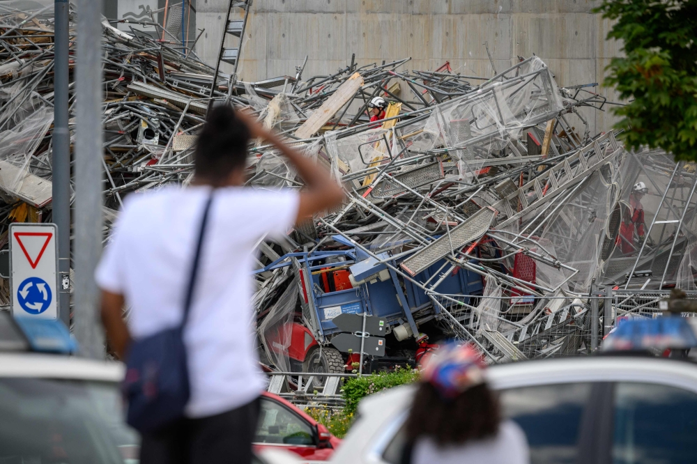 Rescuers work at the site of collapsed scaffolding in the Malley suburb of Lausanne on July 12, 2024. (Photo by Fabrice COFFRINI / AFP)
