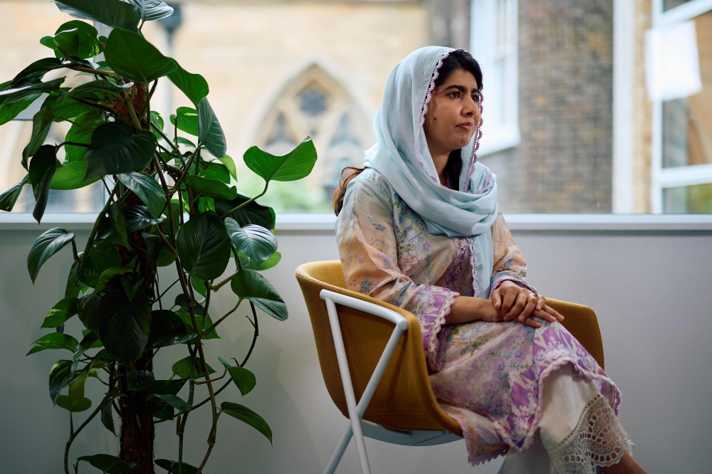 Pakistani Nobel Peace Prize laureate Malala Yousafzai listens to a question during an interview in London on July 12, 2024. (Photo by Benjamin Cremel / AFP)
 