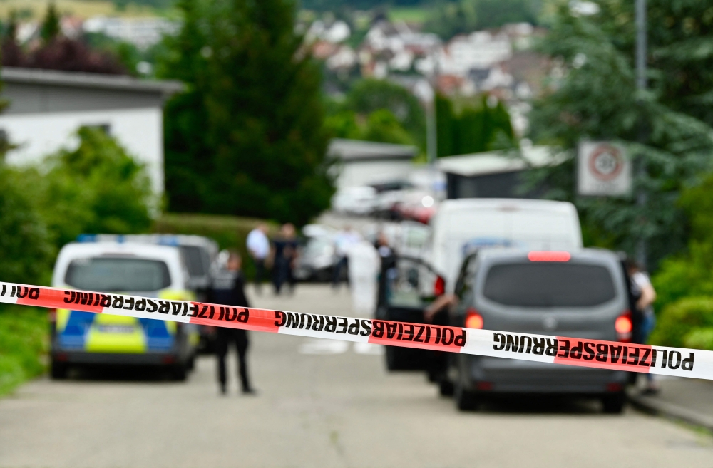 Policemen tape off the site of a crime in Albstadt-Lautlingen near Reutlingen, southern Germany, on July 14, 2024. (Photo by Silas Stein / AFP)
