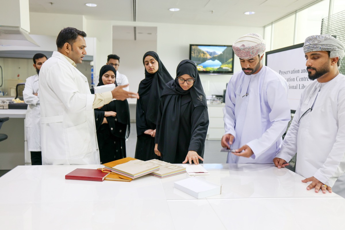 QNL officials with the Omani students during a session of the training programme.