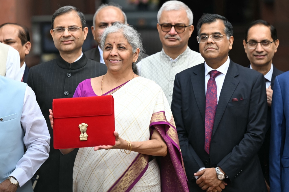 India's Finance Minister Nirmala Sitharaman (C) poses for photos before presenting the union budget in the Parliament in New Delhi on July 23, 2024. (Photo by Sajjad Hussain / AFP)