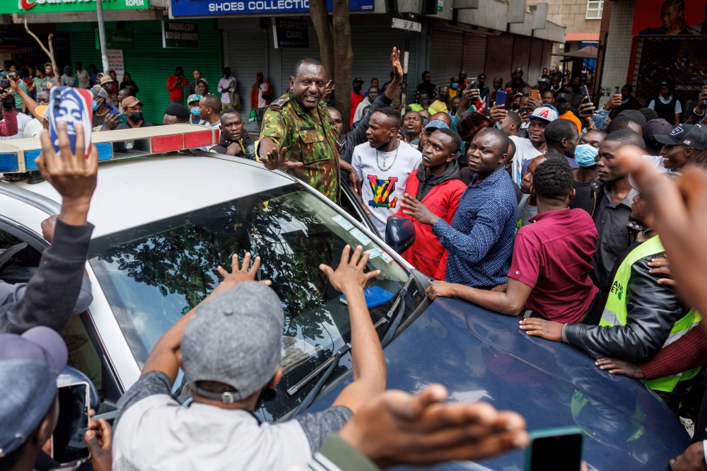 A senior police officer stops to appeal for calm among protestors during anti-government protests to demand accountability from the president Willam Ruto-led government in Nairobi on July 23, 2024. (Photo by Tony KARUMBA / AFP)
