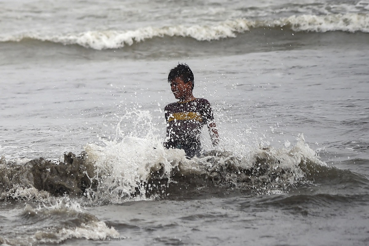 A boy cools off in the Arabian Sea during a hot summer day in Karachi on July 18, 2024. (Photo by Rizwan Tabassum / AFP)