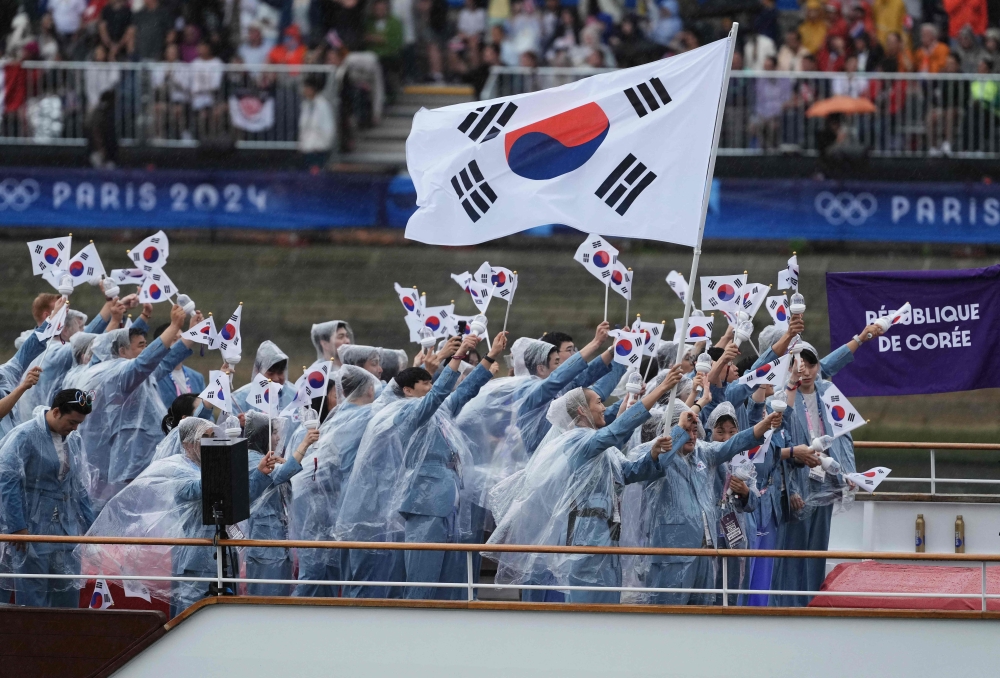 Athletes from South Korea's delegation sail in a boat along the river Seine during the opening ceremony of the Paris 2024 Olympic Games in Paris on July 26, 2024. (Photo by Dimitar Dilkoff / AFP)
 
