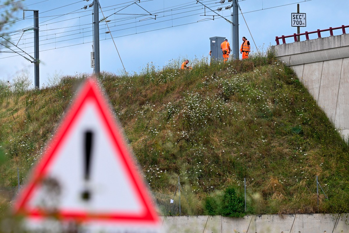 SNCF employees repair the scene of a suspected attack on the Eastern high speed railway network in Vandieres, north eastern France on July 26, 2024, as France's high-speed rail network was hit by an attack disrupting the transport system, hours before the opening ceremony of the Paris 2024 Olympic Games. Photo by Jean-Christophe VERHAEGEN / AFP