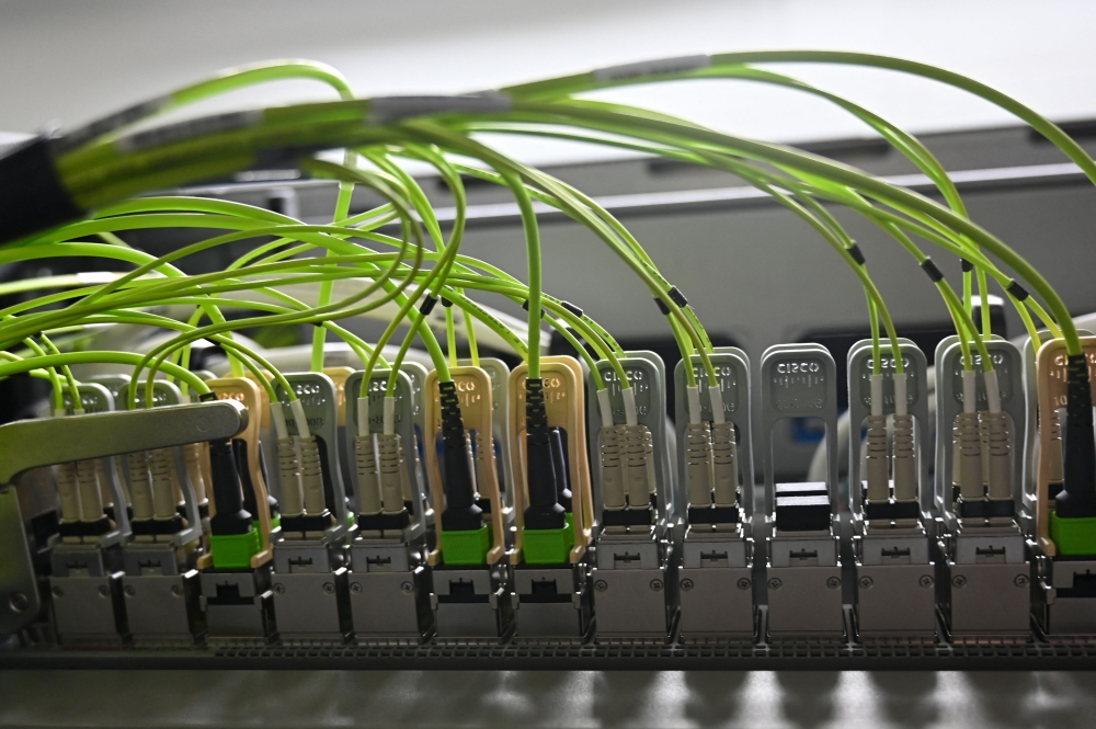 A picture taken on December 14, 2020 shows optical fibers on network infrastructure at the datacenter of French mobile communications company SFR in Cesson-sevigne, in the suburbs of Rennes, western France. Photo by DAMIEN MEYER / AFP