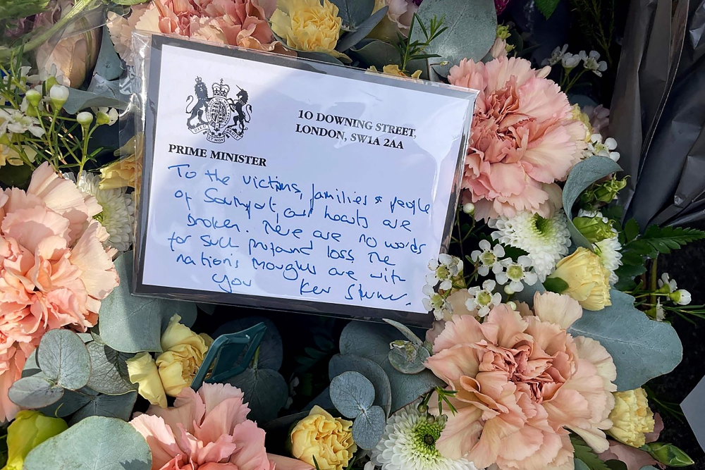 A floral tribute with a message from Britain's Prime Minister Keir Starmer is laid on Hart Street in Southport, northwest England, on July 30, 2024, a day after a deadly knife attack. (Photo by Justine Gerardy / AFP)