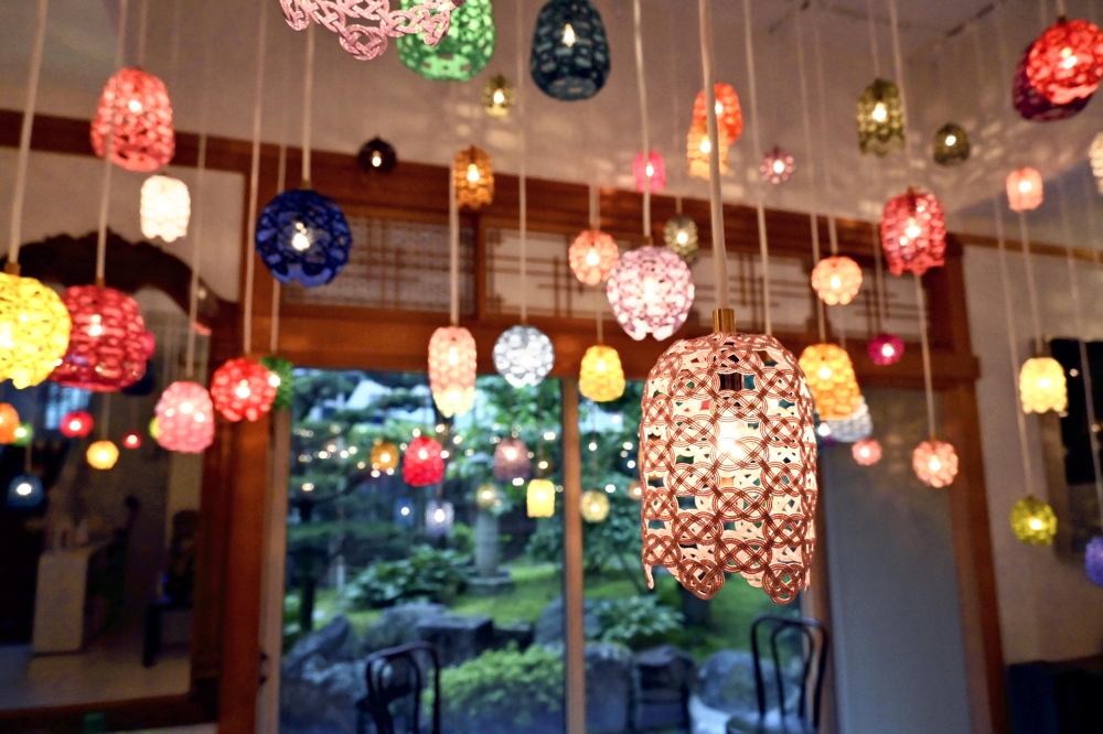 Lamps shaded with mizuhiki creations hang from the ceiling at the museum in Kanazawa. (Photo by The Japan News)