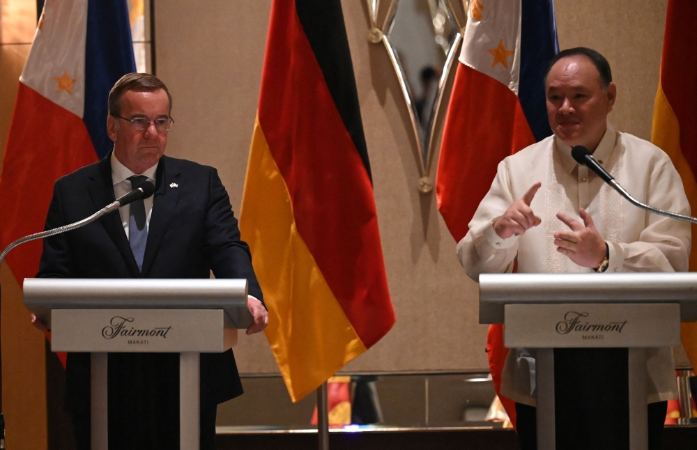 Philippine Defense Secretary Gilberto Teodoro (R) speaks while German Defence Minister Boris Pistorius listens during their joint press conference at a hotel in Manila on August 4, 2024. (Photo by Ted ALJIBE / AFP)