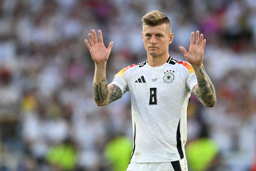 (Files) Germany's midfielder #08 Toni Kroos greets the fans after the UEFA Euro 2024 quarter-final football match between Spain and Germany on July 5, 2024. (Photo by Thomas Kienzle / AFP)