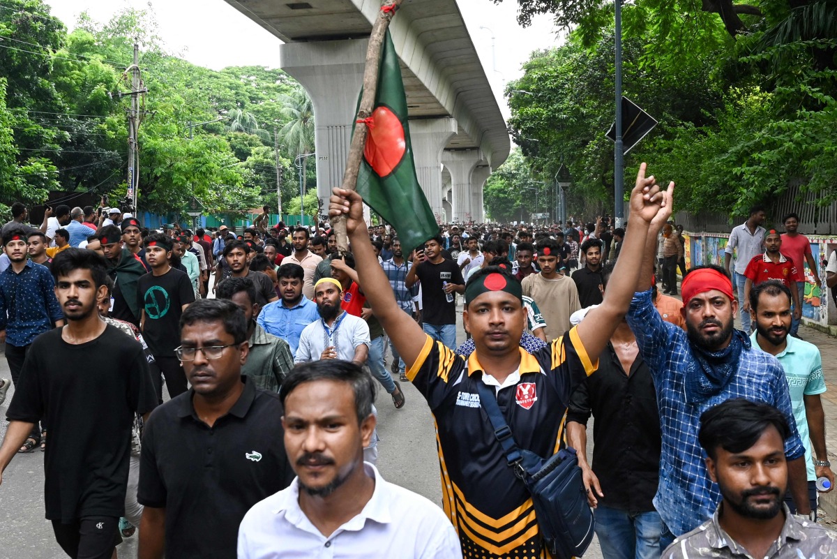 Protesters block the Shahbagh intersection during a protest in Dhaka in August 4, 2024, to demand justice for the victims arrested and killed in the recent nationwide violence during anti-quota protests.  (Photo by Munir UZ ZAMAN / AFP)