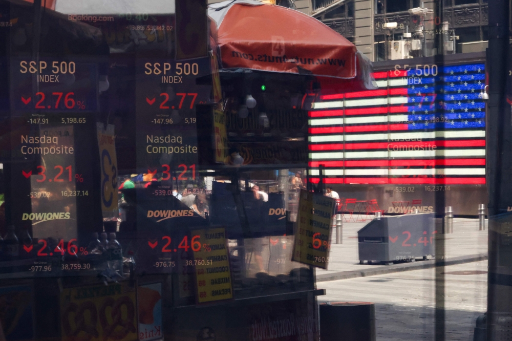 Stock market statistics are displayed in the window of the Nasdaq MarketSite in Times Square in New York City on August 5, 2024. (Photo by CHARLY TRIBALLEAU / AFP)
