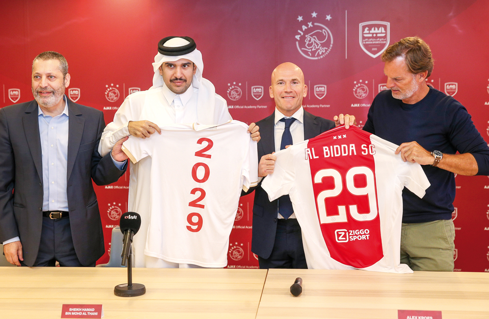 From left: Al Bidda SC's Managing Director Ghassan Oueijan, Al Bidda SC Vice Chairman Sheikh Hamad bin Mohamed bin Fahad Al Thani, Ajax Technical Director Alex Kroes, and Ajax A1 Assistant Manager and Former Netherlands star Ronald de Boer hold Al Bidda club jerseys after announcing the partnership at the Stadium 974, in Doha, yesterday. 