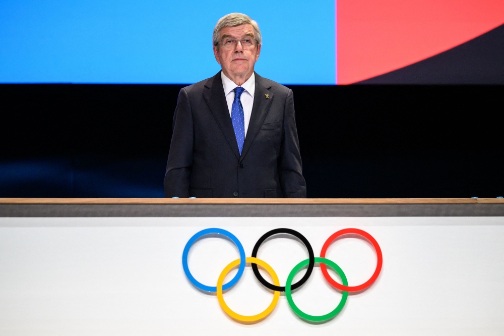 International Olympic Committee (IOC) President Thomas Bach stands during the Olympic anthems during the 142nd session of the IOC in Paris on August 10, 2024, during the Paris 2024 Olympic Games. (Photo by Fabrice COFFRINI / AFP)

