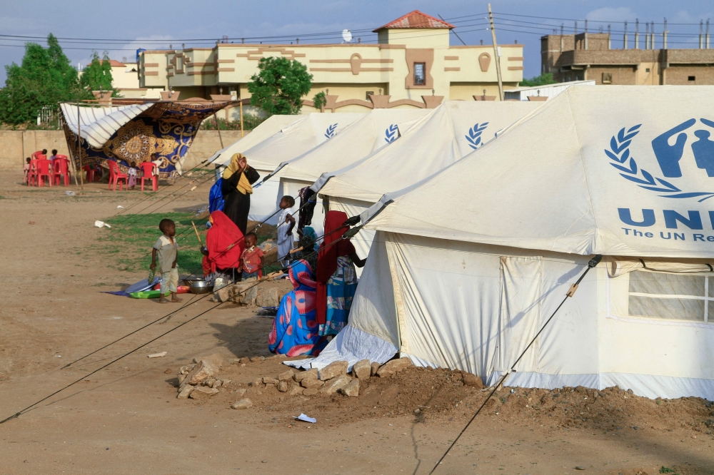 People already displaced by conflict, rest by tents at a makeshift campsite they were evacuated to following deadly floods in the eastern city of Kassala on August 11, 2024. (Photo by AFP)
