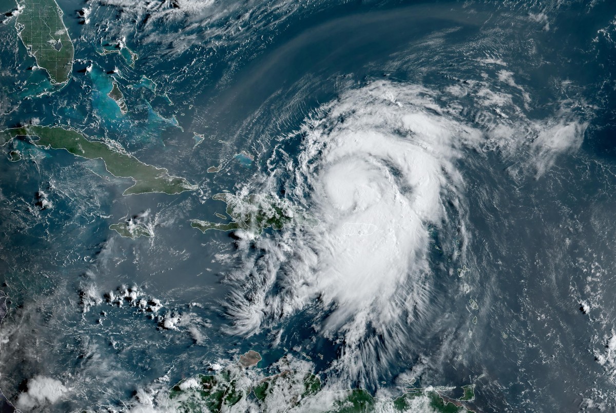 This satellite image obtained from the National Oceanic and Atmospheric Administration shows Tropical Storm Ernesto (C) at 12:10 Zulu on August 14, 2024. Ernesto was moving through the Caribbean on August 14, and was forecast to become a hurricane as it passed north of Puerto Rico, the National Hurricane Center said. Photo by Handout / NOAA/GOES / AFP.