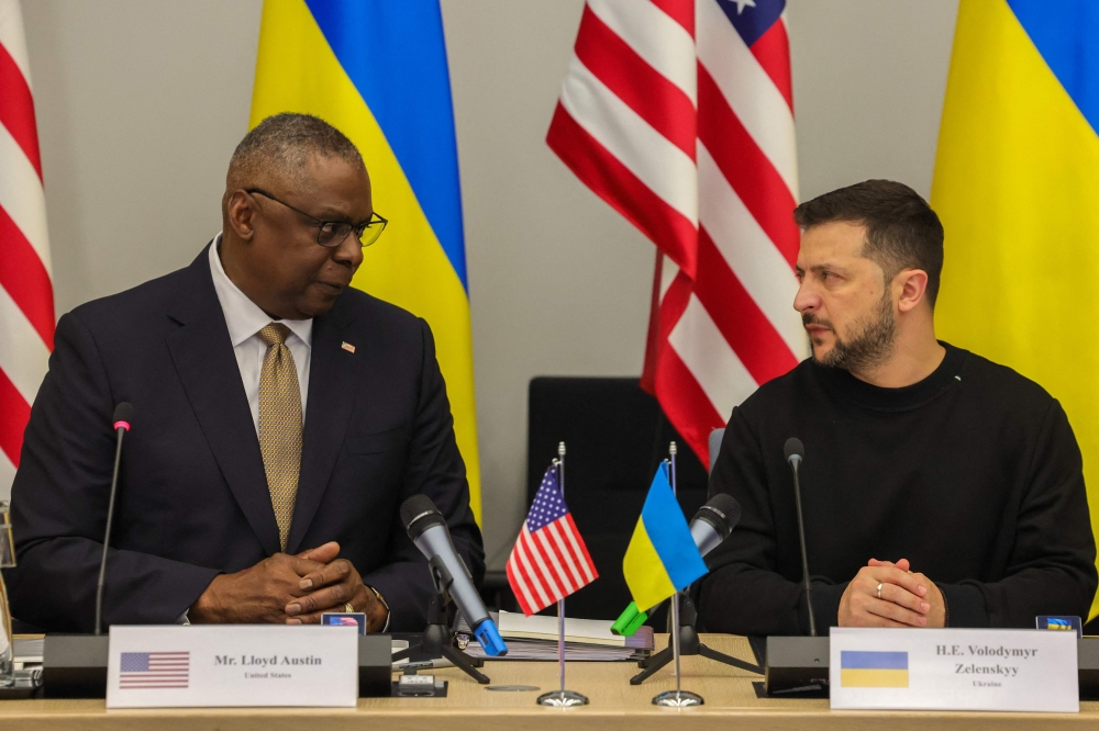 File photo: US Secretary Lloyd Austin (left) talks with President of Ukraine, Volodymyr Zelensky, during a Meeting of the Ukraine Defense Contact Group in Brussels, on October 11, 2023. (Photo by Olivier Matthys / Pool / AFP)