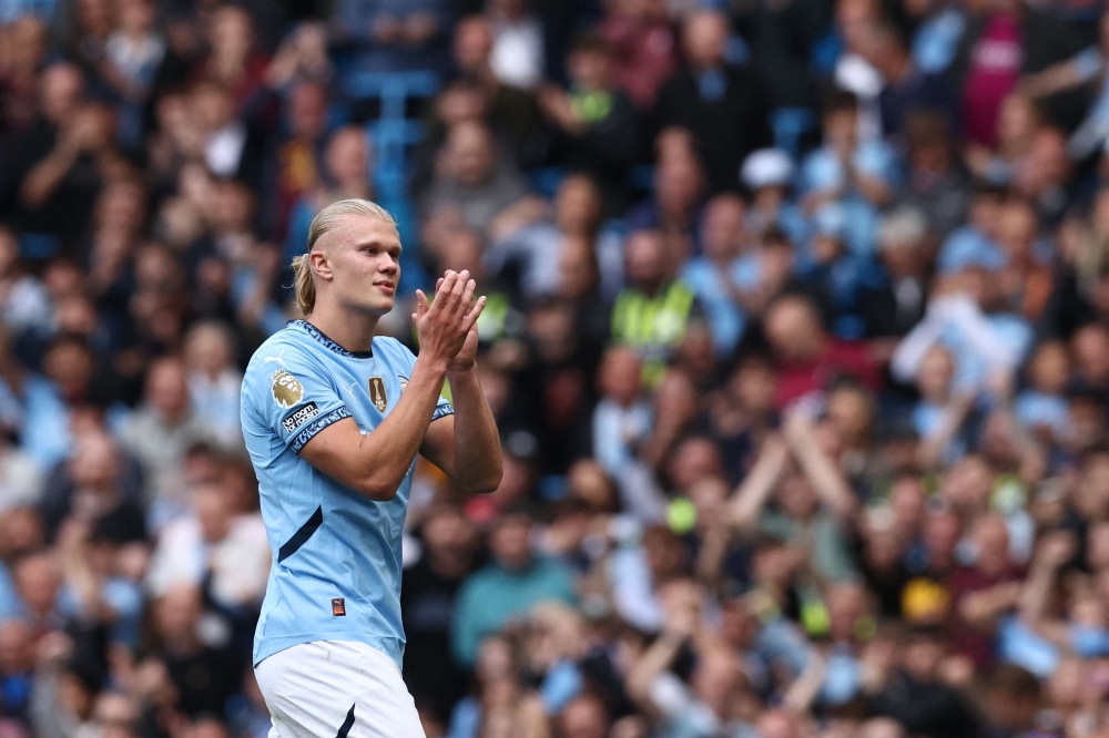 Manchester City's Norwegian striker #09 Erling Haaland applauds fans as he is substituted during the English Premier League football match between Manchester City and Ipswich Town at the Etihad Stadium in Manchester, north west England, on August 24, 2024. (Photo by Darren Staples / AFP) 