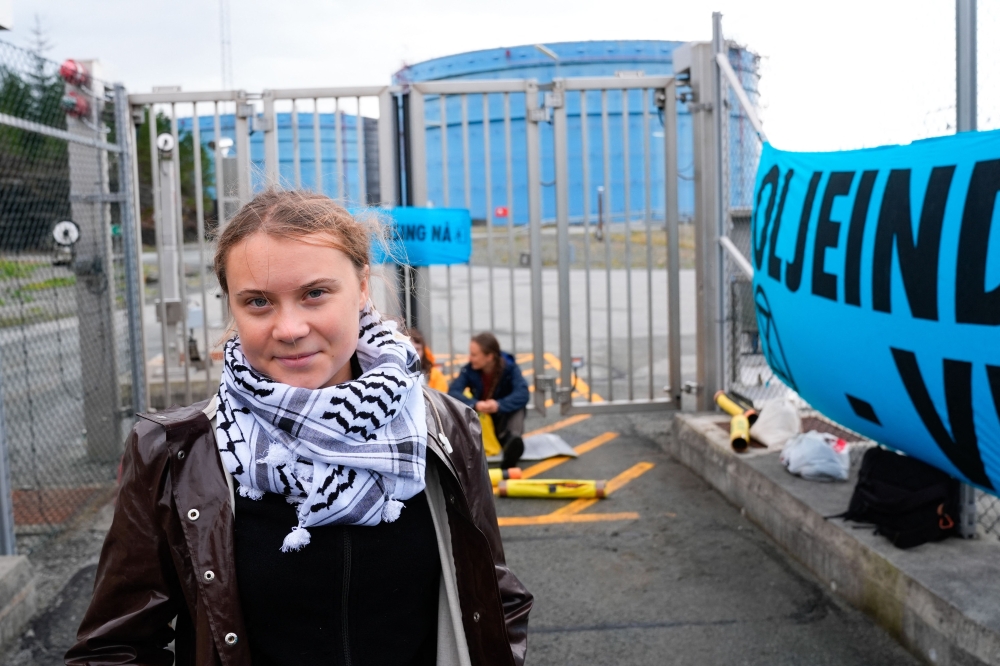 Swedish climate activist Greta Thunberg and activists of the Extinction Rebellion (XR) group campaign against Equinor's processing plant for gas and light oil in Tysvوr near Karsto, Norway, on August 24, 2024. (Photo by Jan Kaare Ness / NTB / AFP) / Norway OUT
