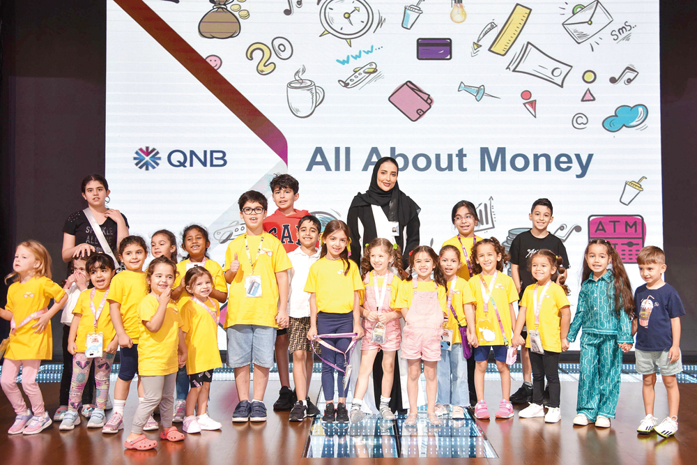 An official along with children pose for a picture during the program.