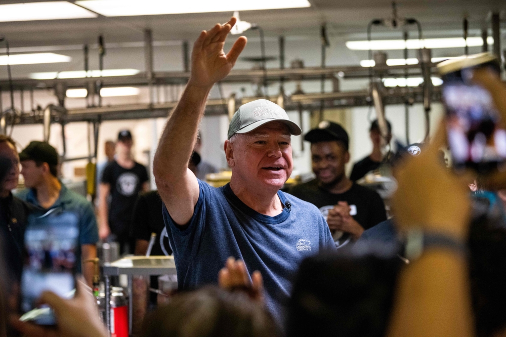 Democratic vice presidential nominee Minnesota Gov. Tim Walz thanks supporters after serving ice cream at the Dairy Barn in the Minnesota State Fair on September 1, 2024 in Falcon Heights, Minnesota. (Photo by Stephen Maturen / GETTY IMAGES NORTH AMERICA / Getty Images via AFP)

