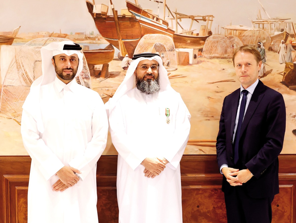 Minister of Municipality H E Abdullah bin Hamad bin Abdullah Al Attiyah (left) witnessing Ambassador of the French Republic to Qatar H E Jean-Baptiste Favre (right) present the Agricultural Order of Merit to Director of the Food Security Department at the Ministry of Municipality Dr. Masoud Jarallah Al Marri.