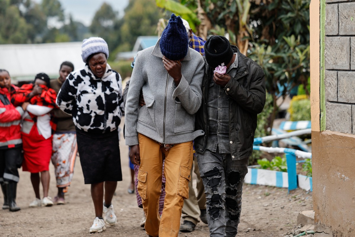 Family members react after visiting the burned dorm room at the Nyeri county's Hillside Endarasha Academy in Nyeri county on September 6, 2024 after a fire broke out killing 17 children. Photo by SIMON MAINA / AFP.