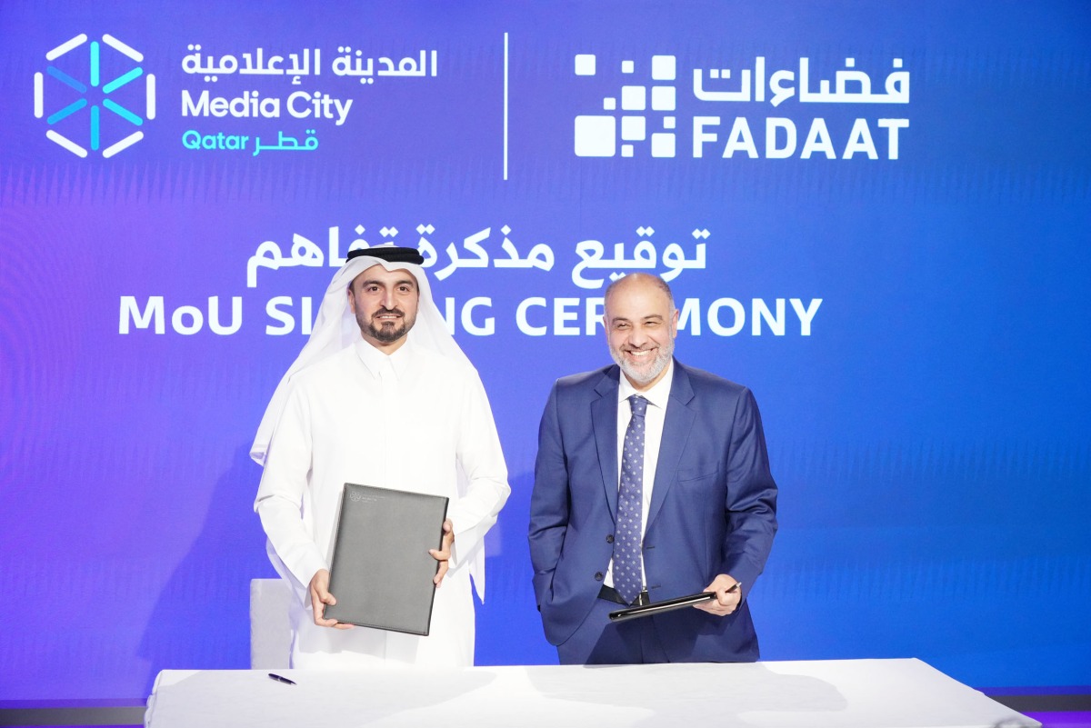 CEO of Media City Qatar Eng. Jassim Mohamed Al Khori (left) and CEO of Fadaat Media Group Maayed Dib exchange documents after signing the agreement.