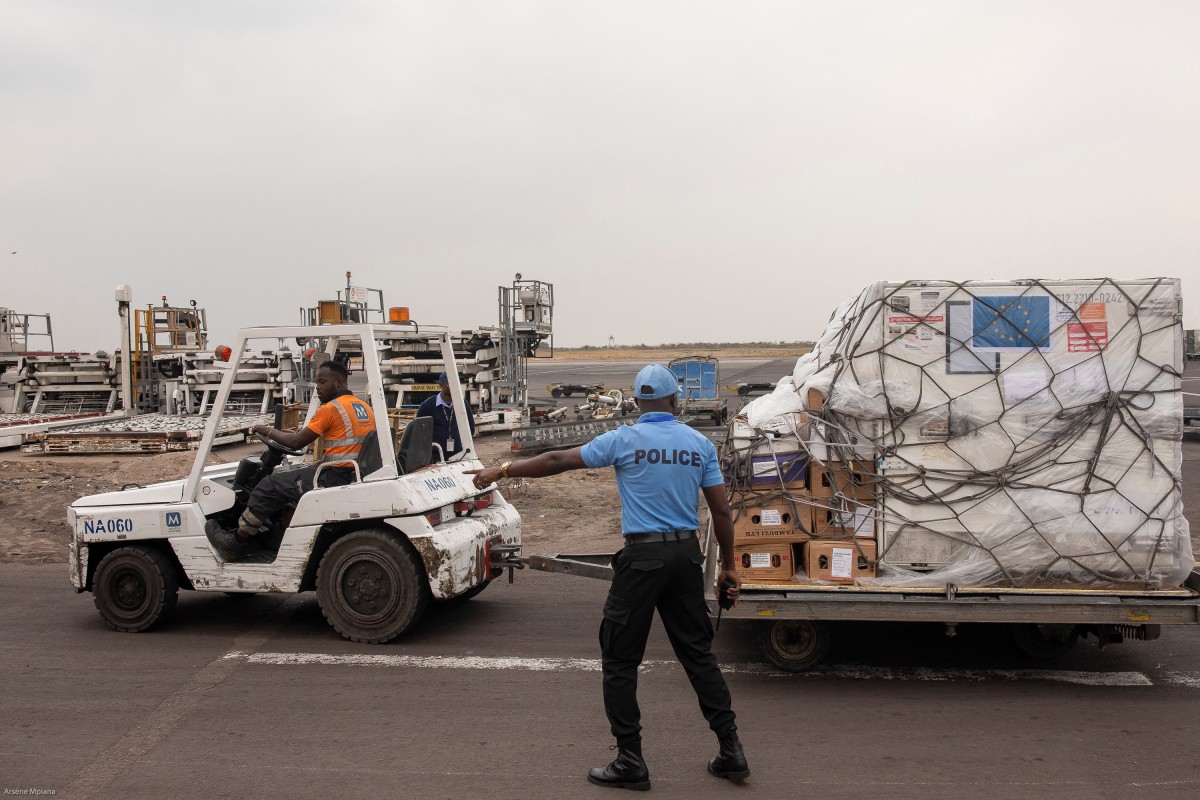 This handout photograph taken and released by the European Union's Press Service on September 5, 2024, shows a policeman gesturing during the reception of a batch of MPOX vaccines donated by European Union at the tarmac of the Kinshasa International Airport in the Nsele district of Kinshasa. Photo by EUROPEAN UNION / AFP.