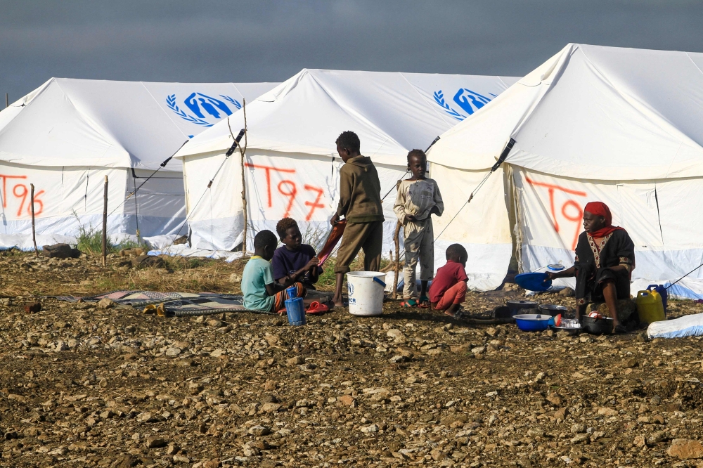 Displaced Sudanese who have returned from Ethiopia gather in a camp run by the United Nations Refugee Agency (UNHCR) in Sudan's border town of Gallabat in the eastern state of Gadaref on September 11, 2024.  (Photo by Ebrahim Hamid / AFP)