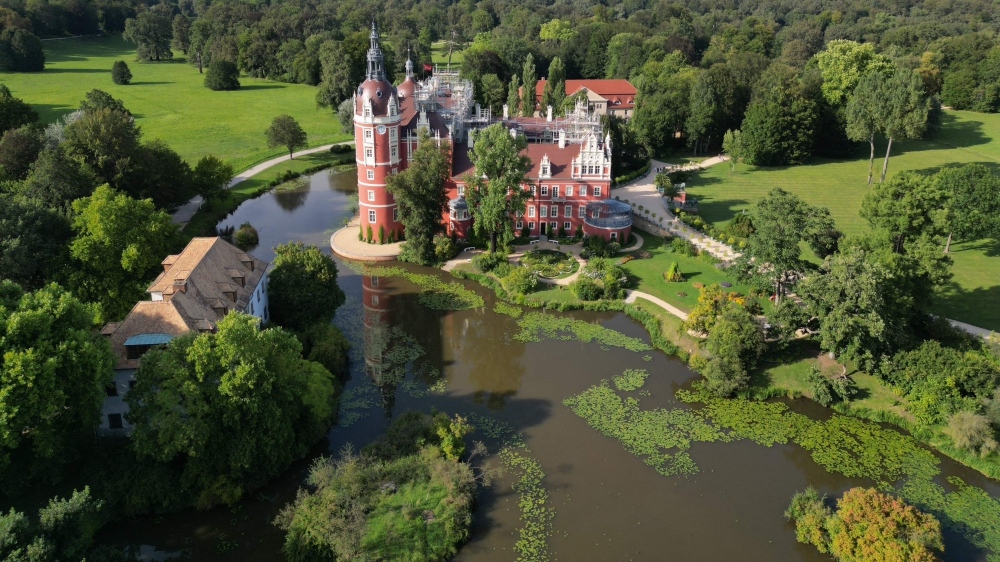 This aerial view shows Bad Muskau palace in the landscape park in Bad Muskau, near Goerlitz in eastern Germany on August 22, 2024. (Photo by Tobias SCHWARZ / AFP)