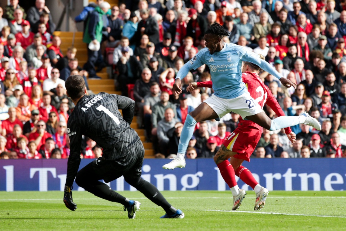 Nottingham Forest's Swedish midfielder #21 Anthony Elanga (front R) jumps for the ball during the English Premier League football match between Liverpool and Nottingham Forest at Anfield in Liverpool, north west England on September 14, 2024. (Photo by Ian Hodgson / AFP) 