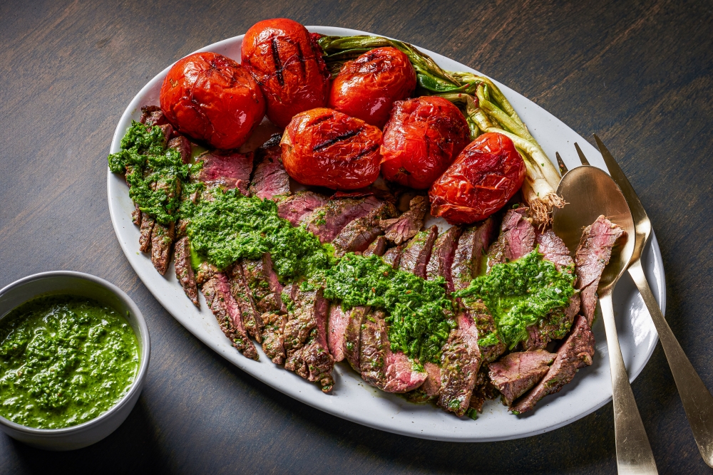 Grilled skirt steak with arugula chimichurri. (Photo by Rey Lopez for The Washington Post; food styling by Lisa Cherkasky for The Washington Post )

