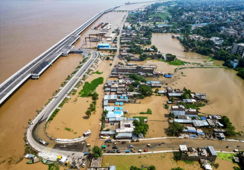 An aerial view shows houses partially submerged in flood, after rise in water level of river Ganges, in Patna on September 20, 2024. (Photo by Sachin Kumar / AFP)

