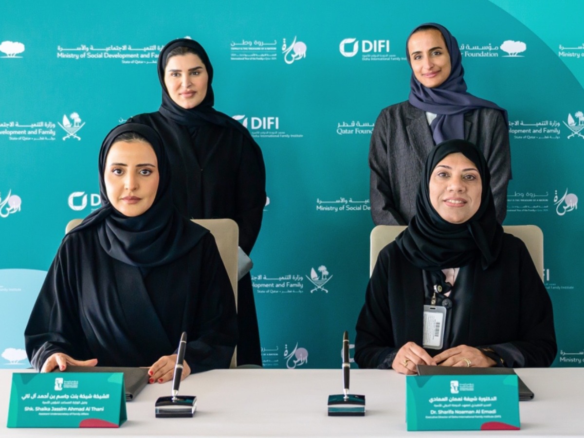 Minister of Social Development and Family H E Mariam bint Ali bin Nasser Al Misnad (left, standing) and Vice-Chairperson and CEO of Qatar Foundation H E Sheikha Hind bint Hamad Al Thani (right, standing) look on as Assistant Undersecretary for Family Affairs, MSDF, Sheikha Sheikha bint Jassim Al Thani (left) and Executive Director DIFI Dr. Sharifa Noman Al Emadi sign the agreement.