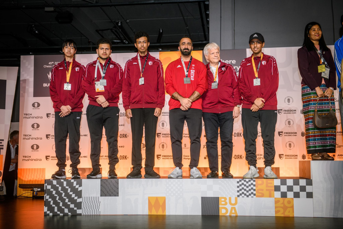 Members of Qatar chess squad pose on the podium. 
