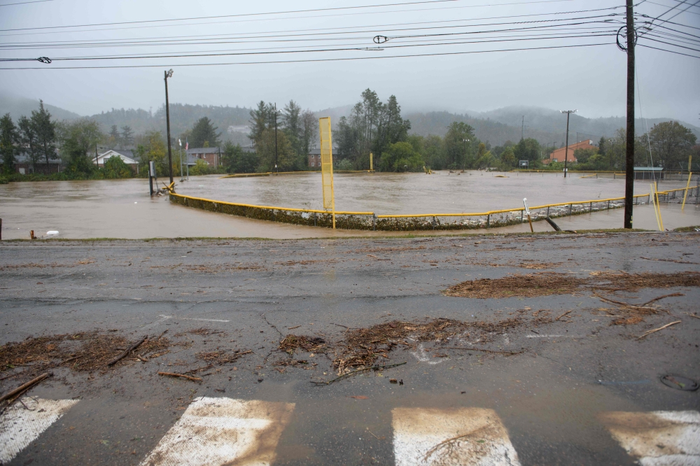 An athletic field is flooded after heavy rain and filling with debris on September 27, 2024 in Boone, North Carolina. Melissa Sue Gerrits/Getty Images/AFP 
 