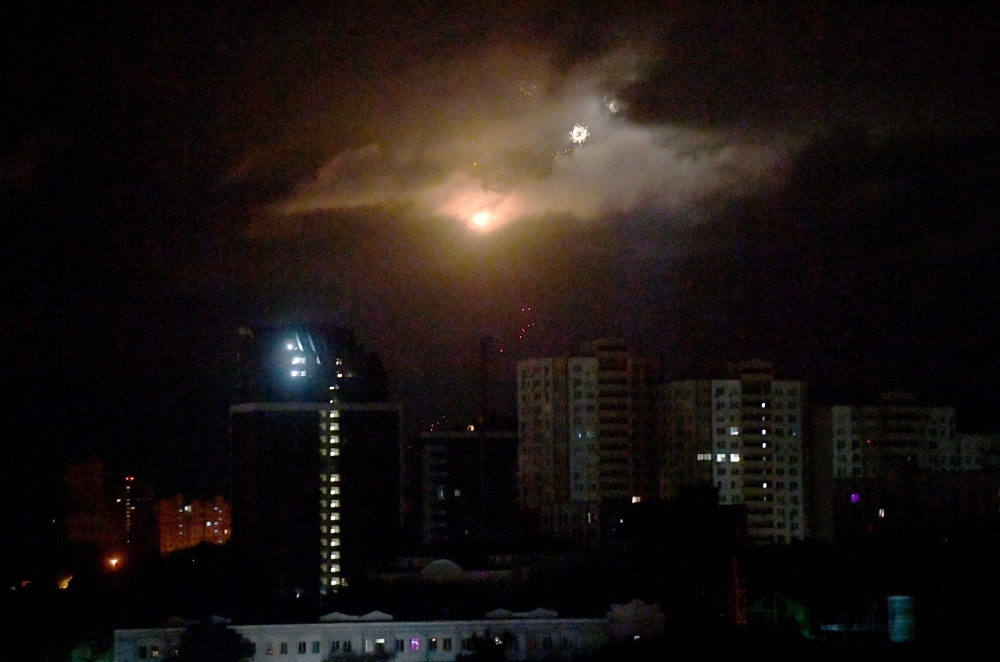 Drones explode as they are being destroyed by Ukrainian air defence during mass night strike to Ukrainian capital of Kyiv on September 30, 2024. (Photo by Sergei SUPINSKY / AFP)
