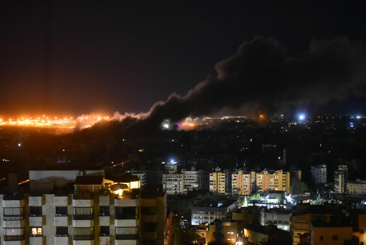 :Smoke rises from the site of an Israeli airstrike that targeted a neighborhood in Beirut's southern suburb early on October 1, 2024. (Photo by Fadel ITANI / AFP)

