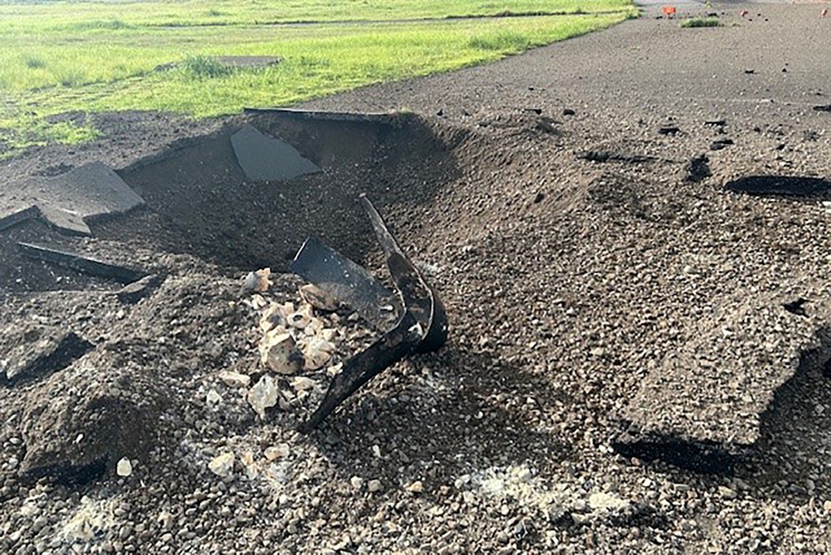 This recent handout photo released to AFP by the Miyazaki Airport Office of the Ministry of Land, Infrastructure, Transport and Tourism on October 4, 2024 shows debris on the edge of the airport tarmac after an unexploded World War II US bomb blew up less than a minute after a passenger jet taxied past on October 2 at Miyazaki airport in southern Kyushu island. Photo by Handout / various sources / AFP