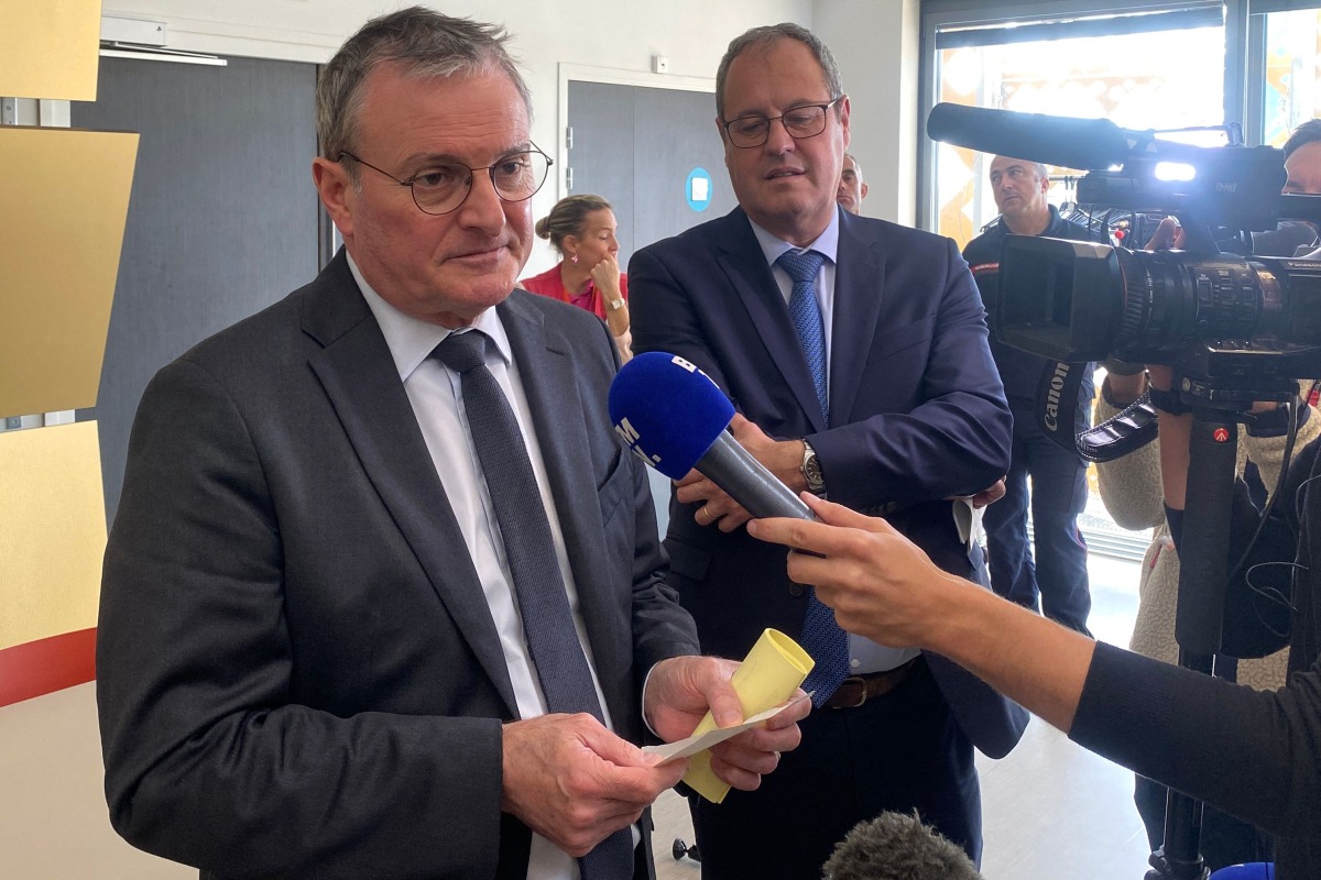 Pas-de-Calais prefect Jacques Billant (L) holds a press conference in Boulogne-sur-Mer on October 5, 2024, following the death of four migrants who attempt to cross the English Channel. (Photo by Matthieu GUILLOT / AFP)
