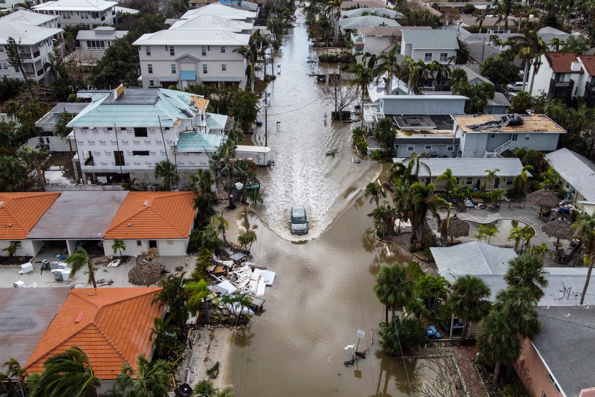 In this aerial photo, a vehicle drives though a flooded street after Hurricane Milton, in Siesta Key, Florida, on October 10, 2024. Photo by CHANDAN KHANNA / AFP.
