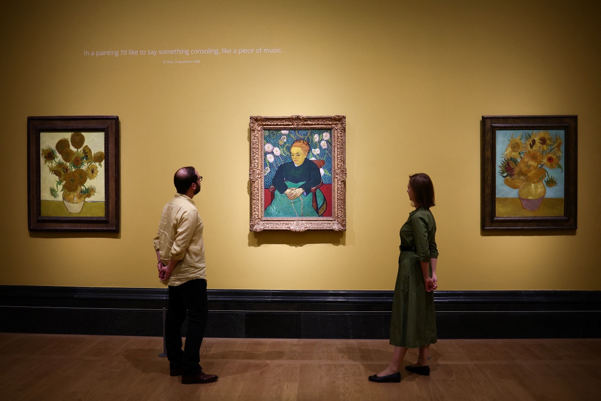 Photo used for demonstration purposes. Visitors look at (from L) three paintings made by late Dutch artist Vincent Van Gogh 