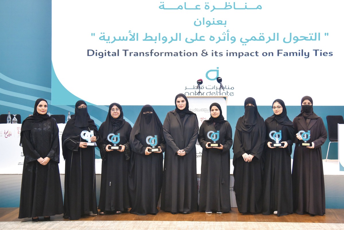 Minister of Social Development and Family H E Maryam bint Ali bin Nasser Al Misnad (centre) with participants at the event.